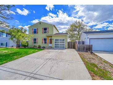 Charming two-story home featuring a well-maintained lawn, clear garage door, and inviting curb appeal at 10704 Moore St, Broomfield, CO 80021
