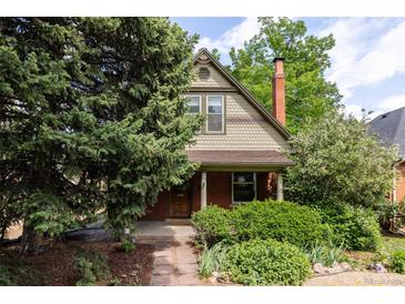 Charming two-story home featuring brick accents and mature landscaping at 4224 N Clay St, Denver, CO 80211