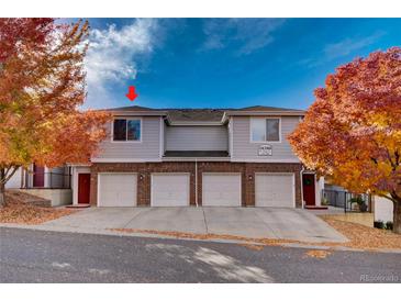 Charming townhouse with brick facade, attached garages, and colorful autumn foliage at 10380 W 55Th Ln # 204, Arvada, CO 80002