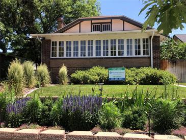 Charming brick home with well-maintained lawn, landscaping, and For Sale sign at 1230 S Emerson St Dr, Denver, CO 80210