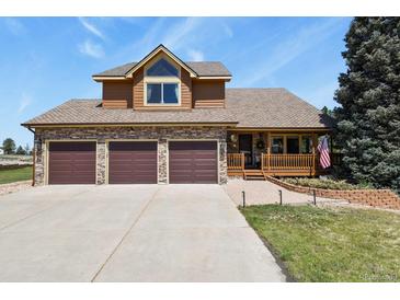 Charming two-story home with a three-car garage, covered porch, and manicured front lawn at 6279 Cheyenne Ct, Parker, CO 80134