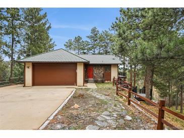 Charming home featuring a tile roof, stone accents, and a convenient attached two-car garage at 723 Eaton Rd, Palmer Lake, CO 80133