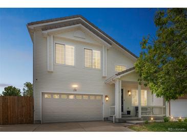 Charming two-story home with an attached garage and inviting front porch at 20338 E 48Th Dr, Denver, CO 80249