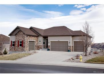 Charming two-story home featuring a three-car garage, stone accents, and a well-maintained yard at 3910 Mighty Oaks St, Castle Rock, CO 80104