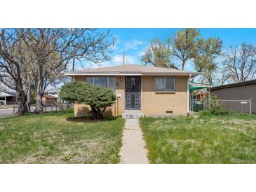 Charming brick home with a tidy front yard and decorative security door at 6933 W 52Nd Pl, Arvada, CO 80002