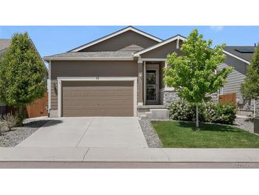 Charming single-Gathering home featuring a well-maintained lawn, a two-car garage, and a welcoming front porch at 55 S Edge Cliff St, Castle Rock, CO 80104