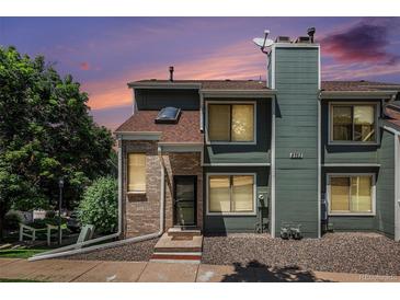 Inviting townhome featuring a blend of brick and siding and colorful evening skies at 8753 W Cornell Ave # 12-1, Denver, CO 80227