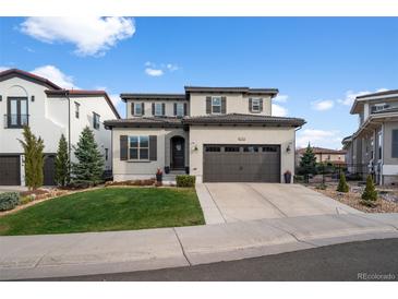 Charming two-story home with a well-manicured lawn and a two-car garage at 9724 Cantabria Pt, Lone Tree, CO 80124