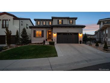 Beautifully landscaped two-story home with a two-car garage and inviting curb appeal at 9724 Cantabria Pt, Lone Tree, CO 80124