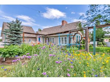 Charming home featuring a colorful wildflower garden in the front yard at 1019 24Th St, Golden, CO 80401