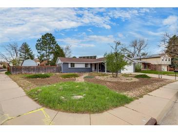 Charming single-story home boasting well-manicured landscaping, blue sky, and a cozy, inviting curb appeal at 3402 S Olathe Way, Aurora, CO 80013