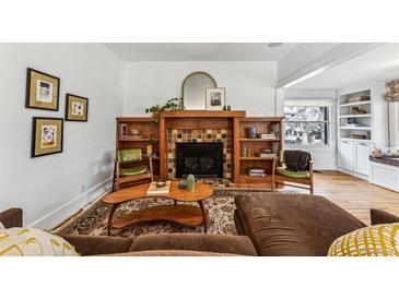 Cozy living room showcasing a fireplace with built-in shelves and a comfortable seating arrangement at 721 Monroe St, Denver, CO 80206