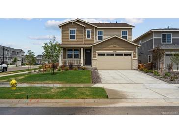 Two-story home featuring a two car garage, front porch and nicely manicured lawn at 24707 E 40Th Ave, Aurora, CO 80019