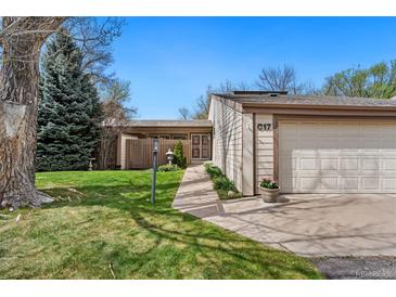 Charming home featuring a landscaped front yard, covered entry, and an attached two-car garage at 6305 W 6Th Ave # C17, Lakewood, CO 80214
