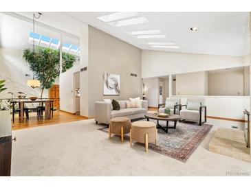 Bright living room with skylights, a cozy seating area, and an indoor tree feature at 6305 W 6Th Ave # C17, Lakewood, CO 80214
