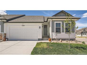 Charming single-Gathering home featuring a two-car garage, landscaped front yard, and inviting front entrance at 11905 Sea Oats St, Parker, CO 80138