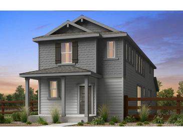 Charming two-story home featuring a covered front porch and craftsman-style details in a tranquil neighborhood at 14857 Arbor W Blvd, Thornton, CO 80602