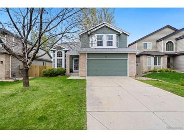 Charming two-story home with a well-manicured lawn and a two-car garage is bathed in sunlight at 1474 E Weldona Way, Superior, CO 80027