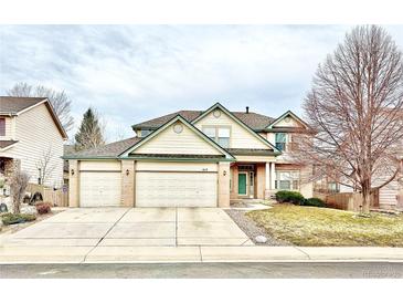 Charming two-story home with a three-car garage and well-manicured lawn at 412 E 131St Ave, Thornton, CO 80241