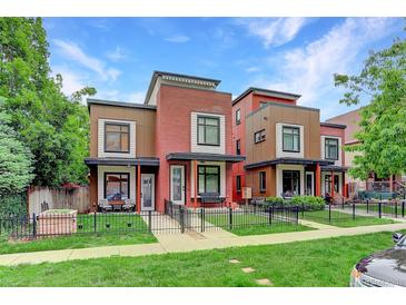 Modern exterior elevation showcasing brick, siding, and a well-maintained front yard with a black metal fence at 2138 N Glenarm Pl, Denver, CO 80205