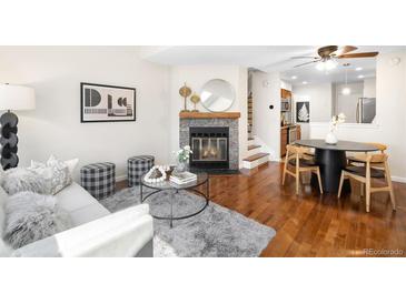 Inviting living room features a cozy fireplace, stylish decor, and hardwood floors throughout the space at 7373 E Iowa Ave # 1124, Denver, CO 80231