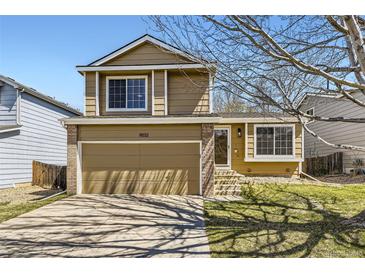Charming two-story home features a two-car garage and inviting curb appeal on a sunny day at 11302 Tumbleweed Way, Parker, CO 80138