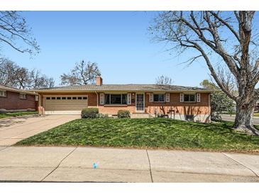 Charming brick home with a well-maintained lawn and an attached two-car garage at 6773 E Baker Pl, Denver, CO 80224