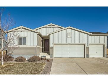 A charming two-story home features attractive siding, complemented by a well-maintained yard and a two-car garage at 2311 Horse Shoe Cir, Fort Lupton, CO 80621