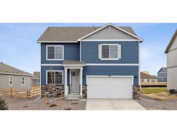 Charming two-story home with a mix of blue siding and stone accents at 779 N Deer Park St, Watkins, CO 80137