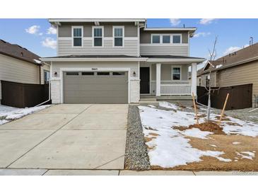 Two-story house with gray siding, attached garage, and small front yard at 9663 Ceylon St, Commerce City, CO 80022