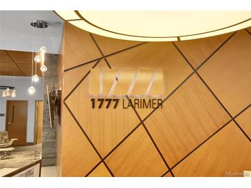 Close up shot of the 1777 Larimer logo in a modern lobby area with pendant lighting at 1777 Larimer St # 902, Denver, CO 80202