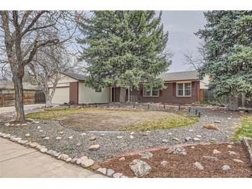 Charming brick home with a well-maintained yard and mature trees at 2056 S Newark Way, Aurora, CO 80014