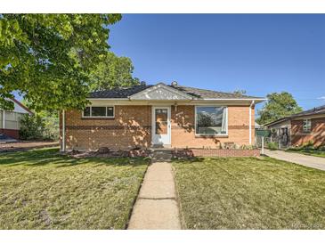 Charming brick home with a well-maintained front yard and inviting walkway, perfect for suburban living at 7060 Avrum Dr, Denver, CO 80221