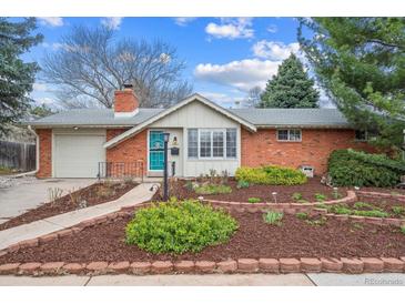 Charming brick home with a well-manicured front yard and a bright blue front door at 3335 S Verbena Ct, Denver, CO 80231