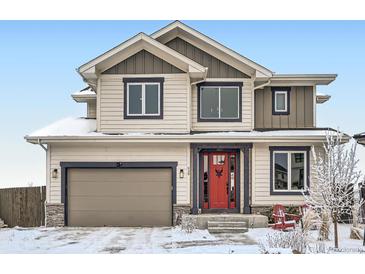 Charming two-story home featuring a red door and a neutral color scheme, complete with an attached two-car garage at 938 Larkspur Ln, Louisville, CO 80027