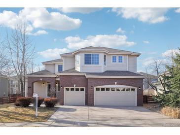 Charming two-story home with a brick facade and three-car garage at 5352 Brookside Dr, Broomfield, CO 80020