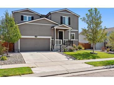 Two-story house with gray siding, attached garage, and landscaped yard at 6112 Black Mesa Rd, Frederick, CO 80516