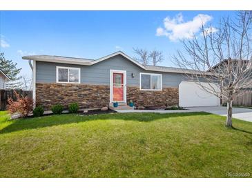 Charming single-story home with stone accents, landscaped yard, and mature tree at 6074 S Dudley Way, Littleton, CO 80123