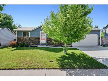 Charming single-story home with a well-manicured lawn, stone accents, and mature trees in a desirable neighborhood at 6074 S Dudley Way, Littleton, CO 80123