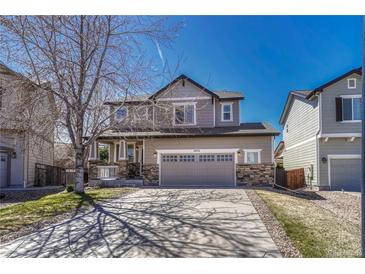 Charming two-story home featuring stone accents, a spacious two-car garage, and a well-manicured front lawn at 2976 Open Sky Way, Castle Rock, CO 80109