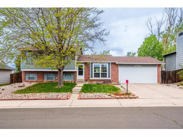 Charming two-story home featuring a landscaped front yard, brick accents, and an attached two-car garage at 18472 E Atlantic Dr, Aurora, CO 80013