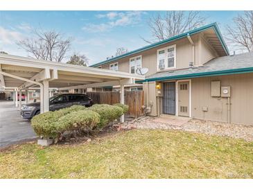 Inviting townhome showcasing a carport, well-manicured lawn, and attractive exterior paint scheme at 5928 S Willow Way, Greenwood Village, CO 80111