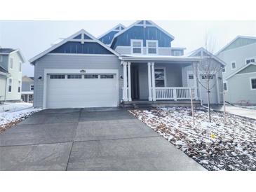 Charming home featuring a covered front porch, attached garage, and well-kept landscaping at 39876 Floyd St, Elizabeth, CO 80107