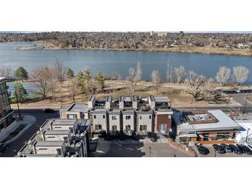 Stunning aerial view of modern townhomes overlooking a picturesque lake and tennis court at 4072 W 17Th Ave, Denver, CO 80204