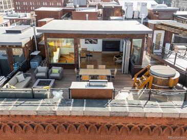 Expansive rooftop deck with lounge area, hot tub, dining space, and indoor-outdoor flow at 1792 Wynkoop St # 508, Denver, CO 80202