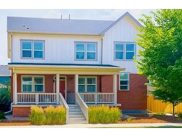Charming two-story home with a inviting brick porch and well-maintained lawn at 5404 W 95Th Pl, Westminster, CO 80020