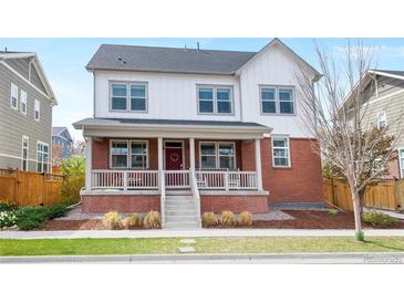 Charming two-story home featuring a welcoming front porch and classic red brick accents at 5404 W 95Th Pl, Westminster, CO 80020