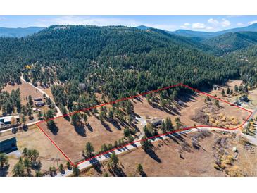 Gorgeous property lot surrounded by mature trees and beautiful mountain views at 87 Elmgreen Ln, Evergreen, CO 80439