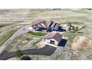 Expansive property featuring a custom home, detached garage, and picturesque views of the surrounding landscape at 220 High Meadows Loop, Elizabeth, CO 80107