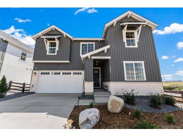 Attractive two-story home featuring gray siding, white brick accents, and an attached two-car garage at 3444 Recess Pt, Castle Rock, CO 80108